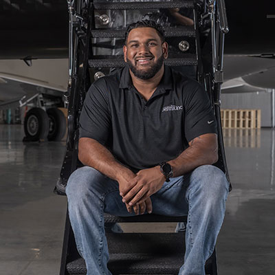 Jamaal Khan sitting on private jet loading stairs Jamaal Khan sitting on private jet loading stairs